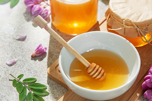 Natural honey in bowls and jars with robinia flowers, a Food & Drink Photo by Olena Rudo