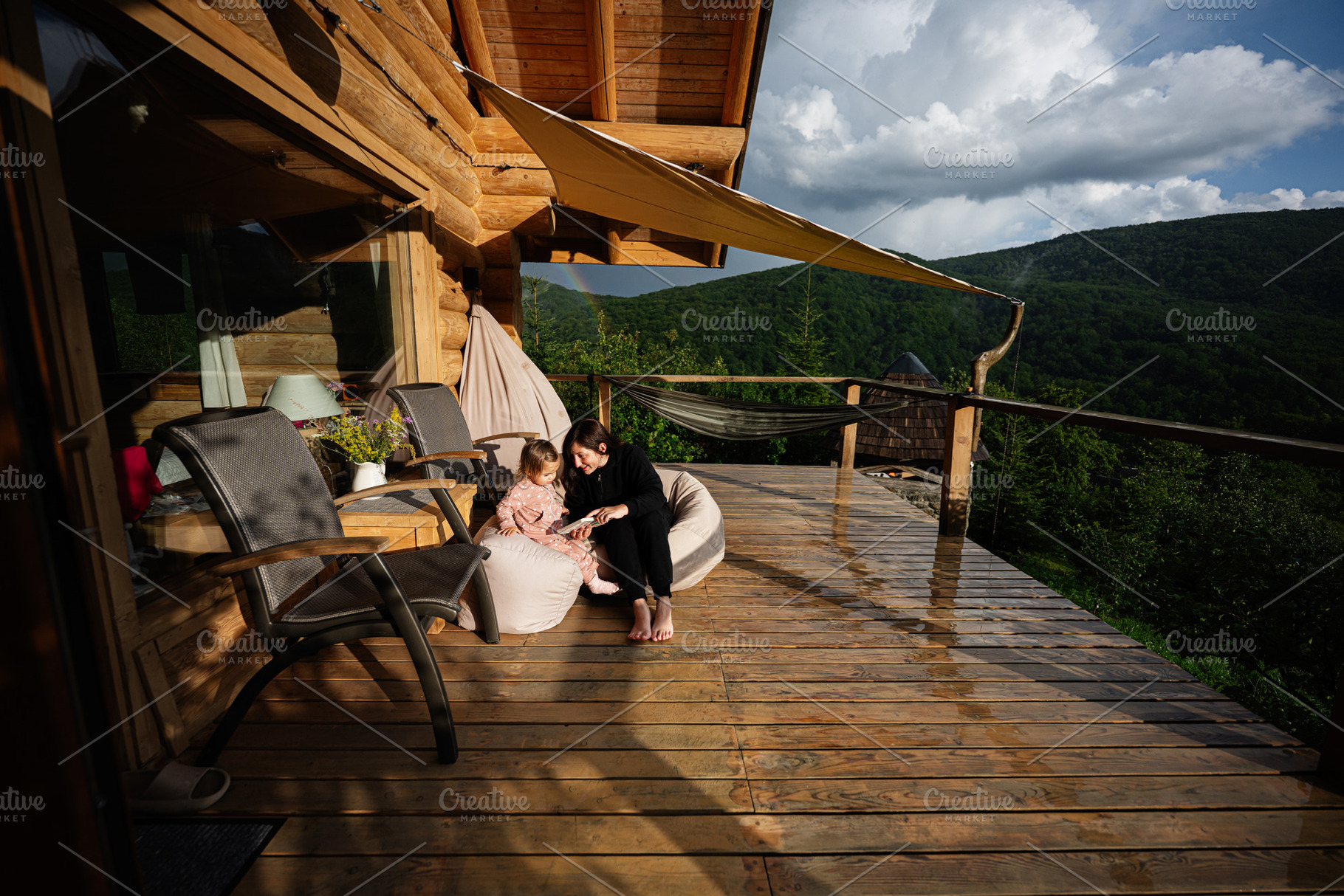 Mother and child bonding on a wooden terrace in a serene forest setting, a Photo by AS photostudio