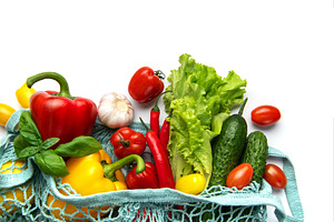 Fresh organic vegetables in reusable shopping bag on white, a Food & Drink Photo by Olena Rudo