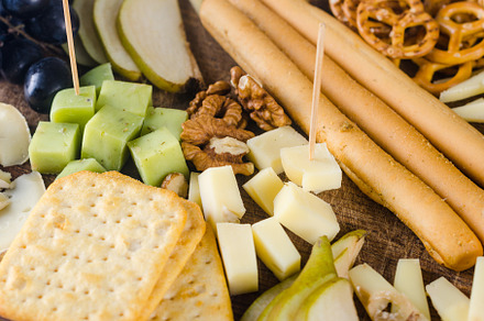 Delicious cheese mix with grapes, jam, snacks, crackers, walnuts, a Food & Drink Photo by vimart