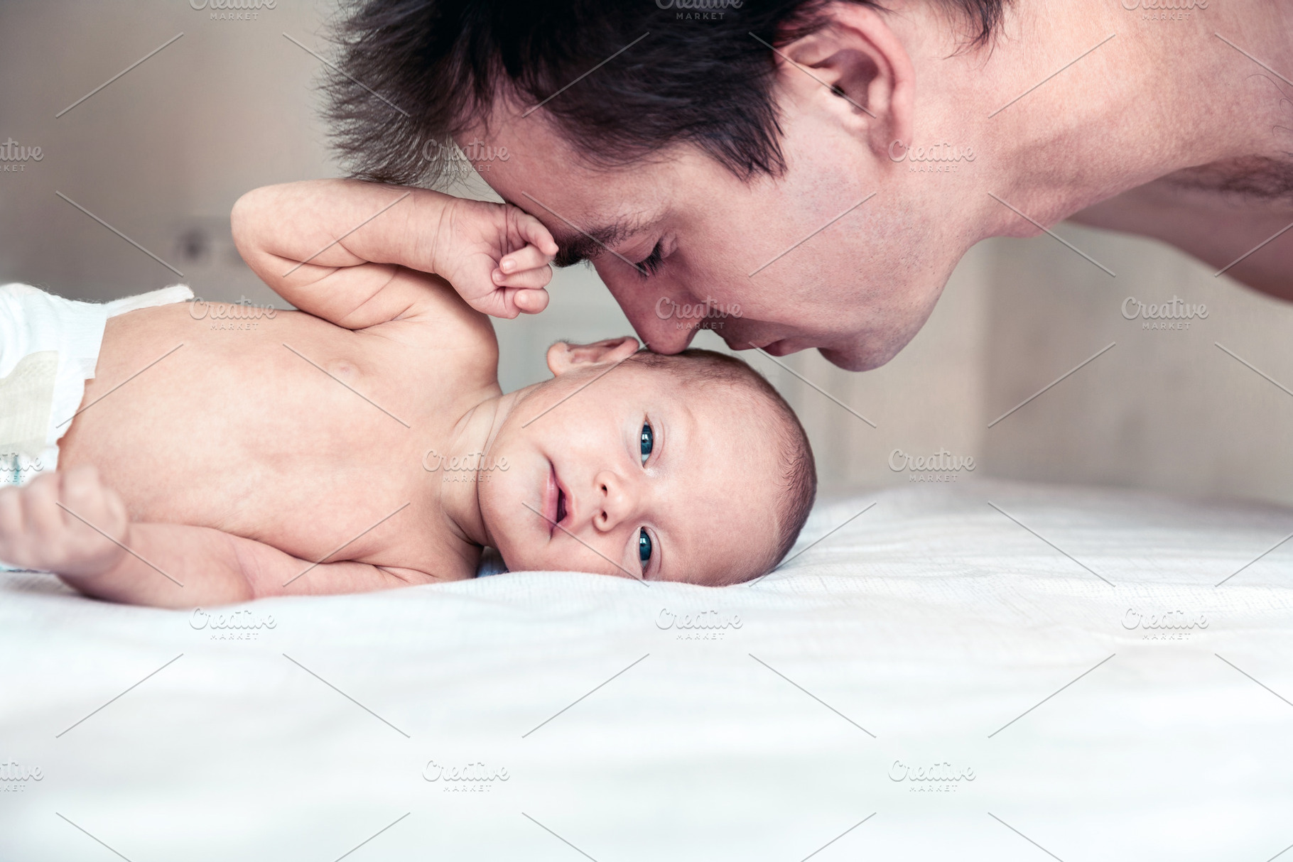 a father kisses his newborn son, a Person Photo by Eni_fly