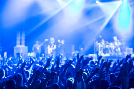 Crowd at concert and blurred stage lights  featuring crowd, people, and event