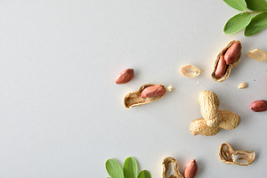 Background with detail of peanuts on white table, a Food & Drink Photo by Davizro's Market