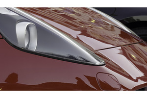 Red sports car reflecting city, a Transportation Photo by Media Whale Stock