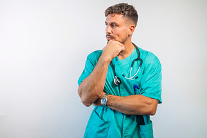 Doctor Thinking with Hand on Chin, a Person Photo by karrastock