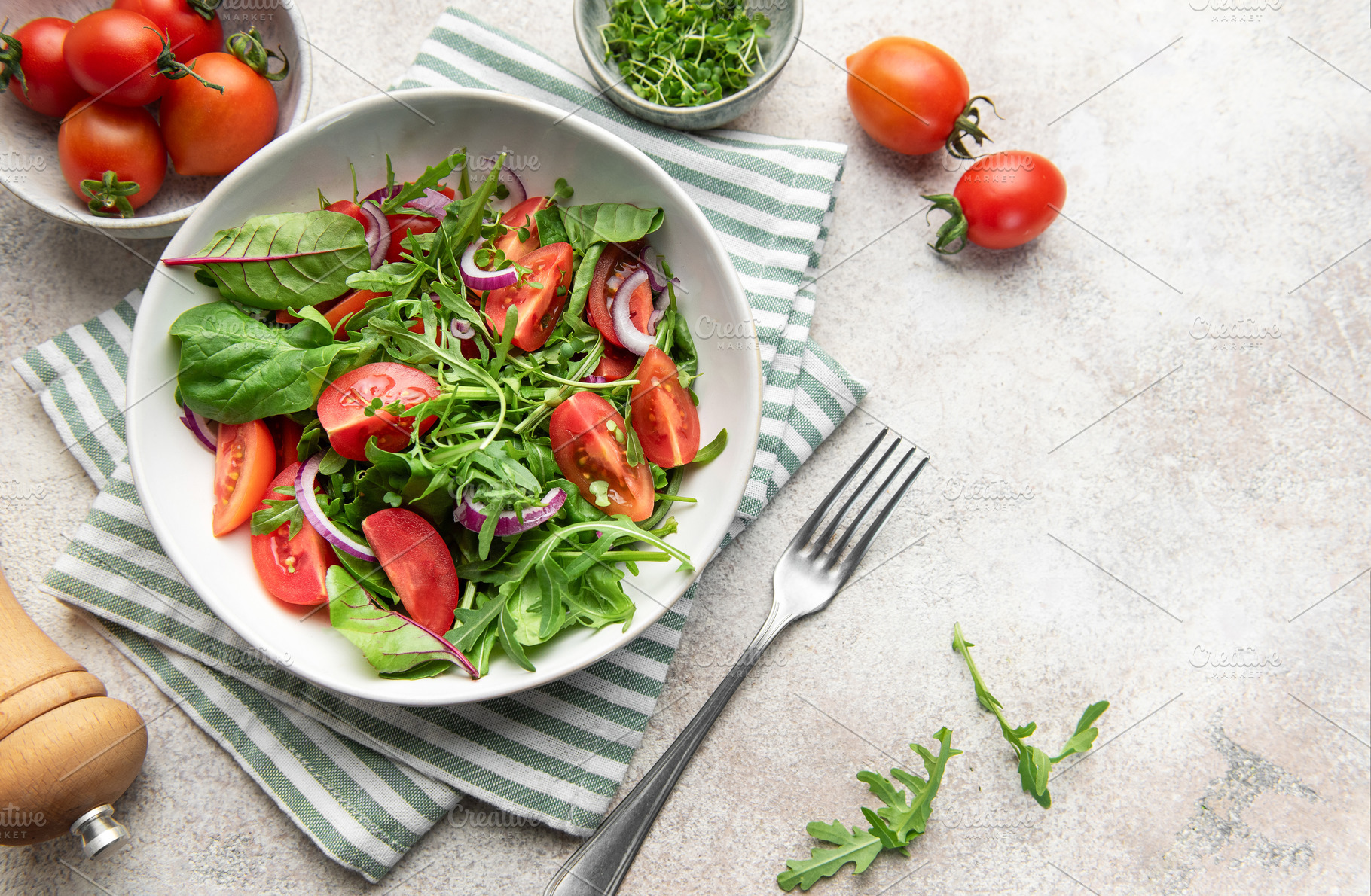 Fresh green salad with tomatoes and arugula, a Food & Drink Photo by Olena Rudo