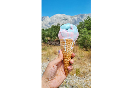 Melting gelato ice cream cone held, a Food & Drink Photo by Beautiful things
