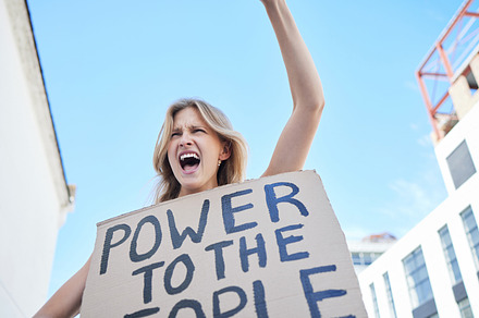 Power to the people, sign and woman protest human rights freedom, justice and democracy in city social rally. Feminist shout, empowerment poster and support equality, community and society revolution, a Photo by Peopleimages.com