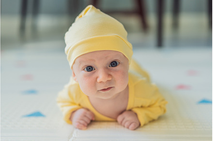 One-month-old baby lying on tummy