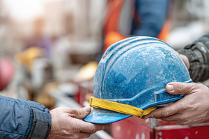 Workers exchange hard hat at site, a Photo by Beautiful things