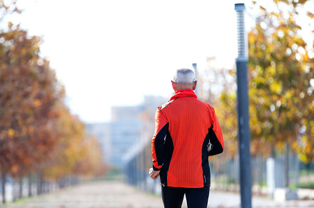 Senior man jogging in the park on a sunny day