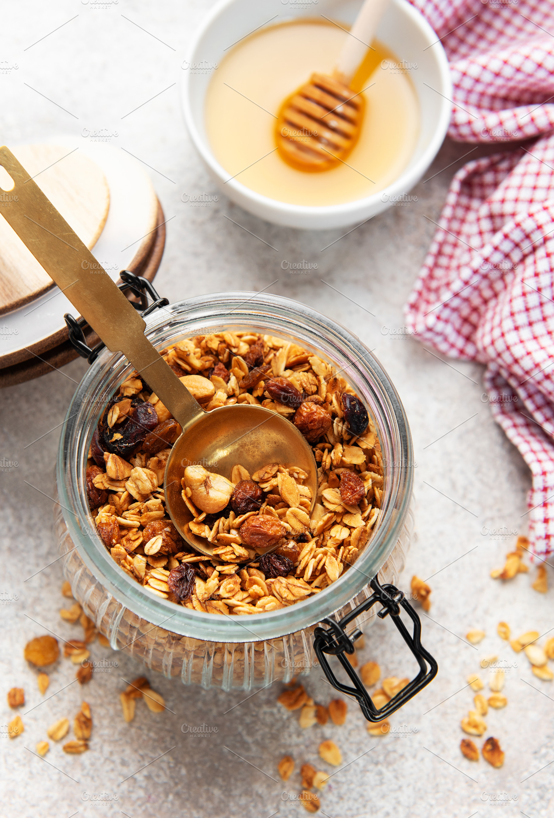 Granola with nuts and dried fruits in jar, a Food & Drink Photo by Olena Rudo