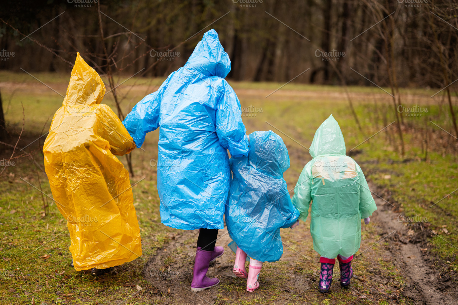 Rear view of mother and three children walking in the forest aft, a Person Photo by AS photostudio