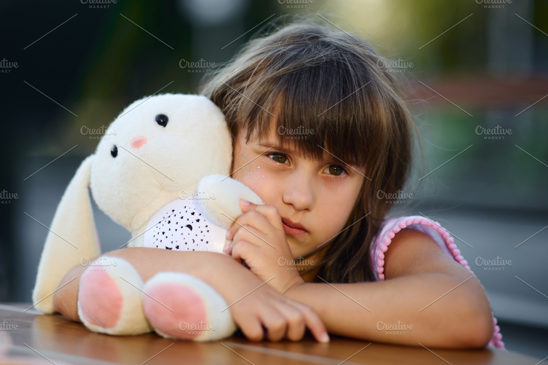 Close-up thoughtful portrait of a little girl hugging her plush bunny toy., a Person Photo by Rohan Photography
