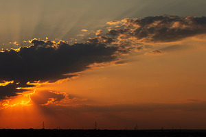 Orange sunset with sun rays shining, a Wallpaper Photo by Elena Vagengeim