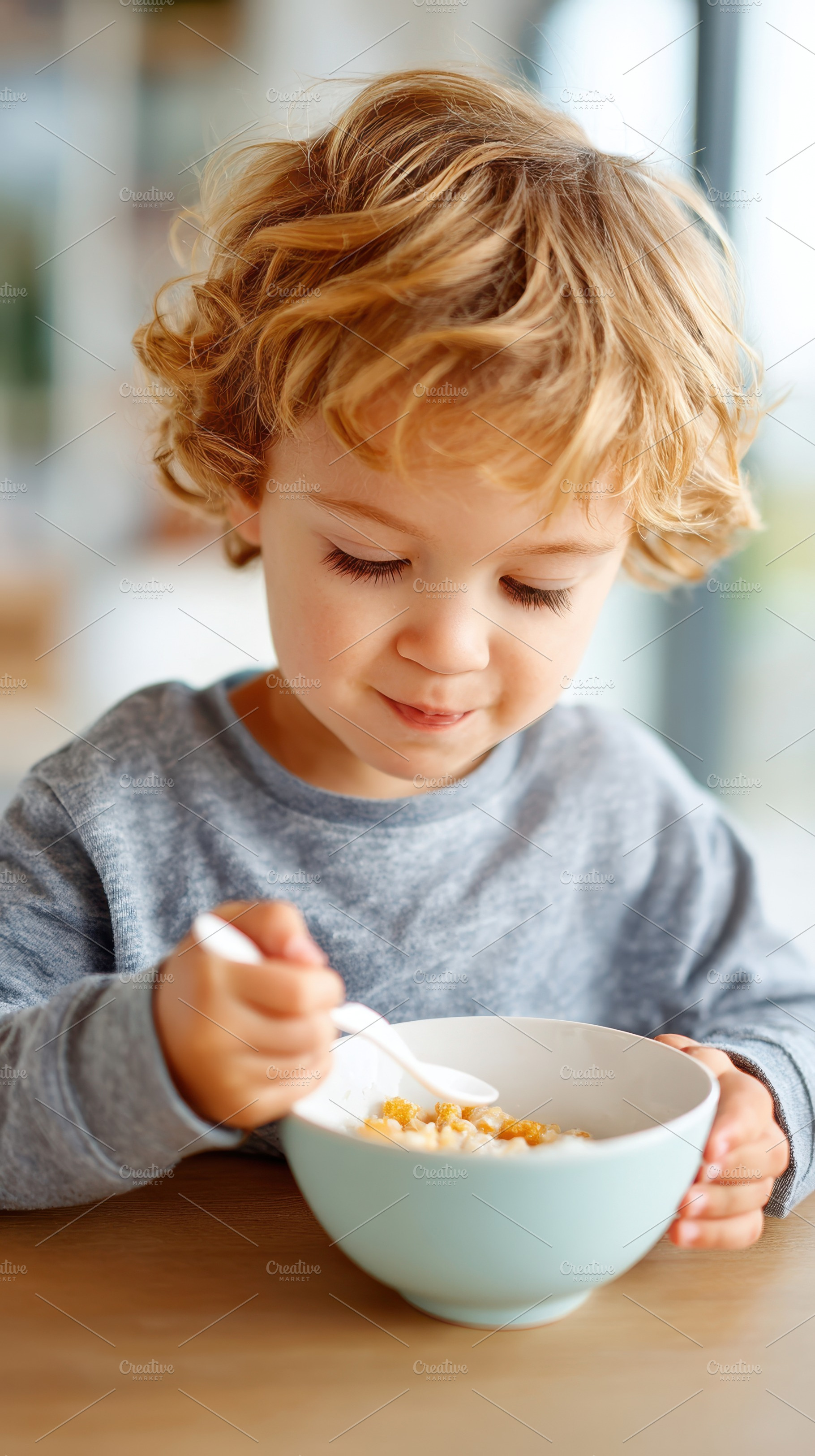Child enjoying breakfast cereal, a Person Photo by AlyaAnd