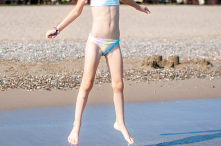Little girl playing on the beach by the sea, a Holiday Photo by Olena Rudo