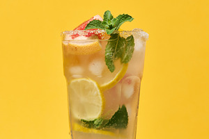 Glass with a cold drink, grapefruit slices, ice, mint and lemon, a Food & Drink Photo by ndanko