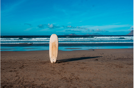 Surfboard in sand on a sunny beach, a Sports & Recreation Photo by HalfPoint