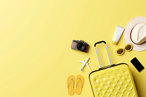 Summer travel accessories flat lay on yellow background, a Holiday Photo by RF Images