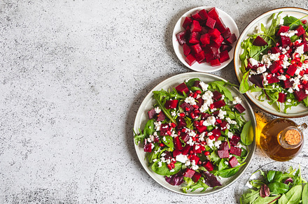 Arugula, Beet and cheese salad with pomegranate and dressing on, a Food & Drink Photo by Ivanna