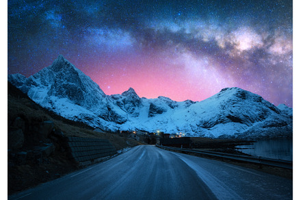 Milky Way over road, snowy mountains
