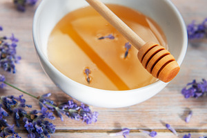 Honey in bowl with lavender flowers and dipper, a Food & Drink Photo by Olena Rudo