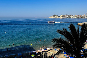 Scenic sea view of Benidorm Spain with beachgoers and skyscrapers along the coa, a Photo by AS photostudio