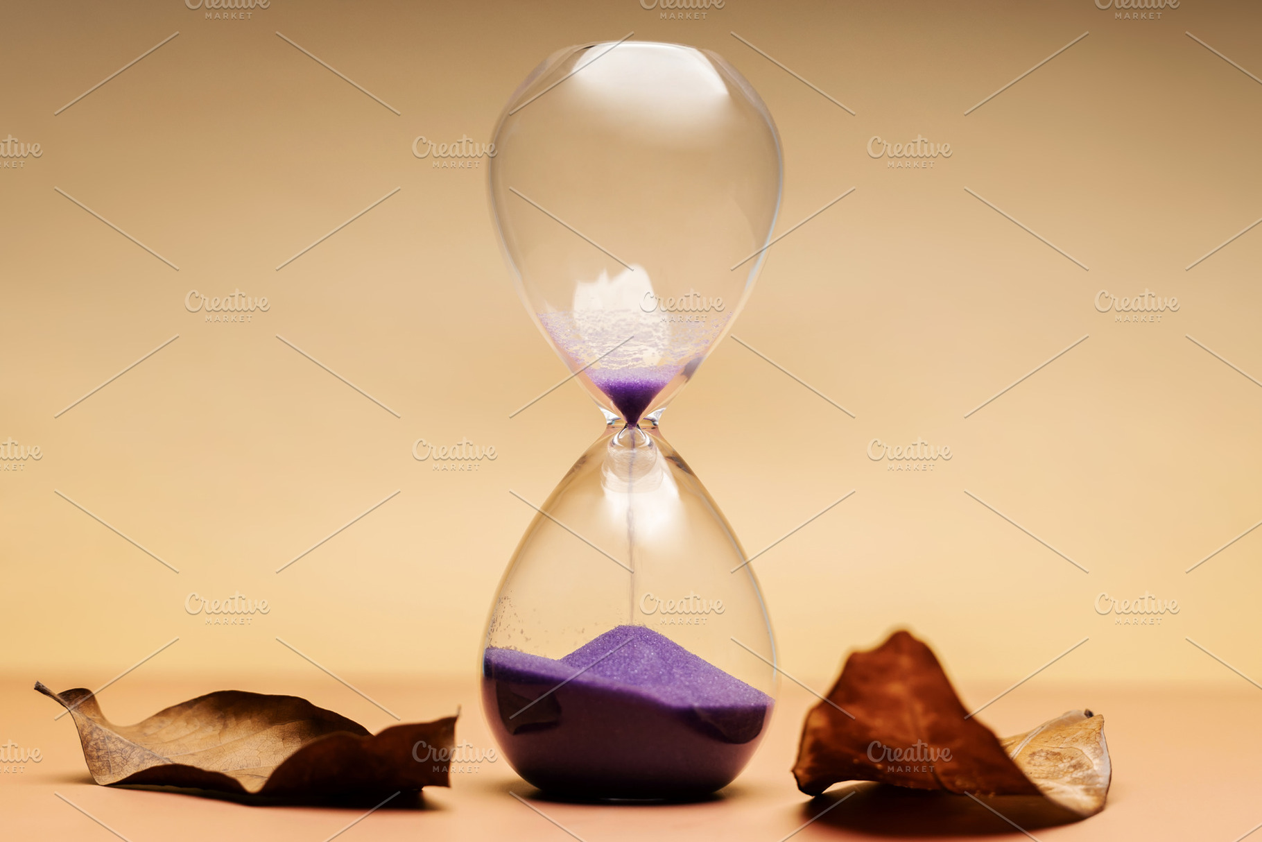 Hourglass with dried leaves, aging process, seasonal life transi, a Photo by salmon.black