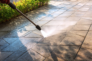 Power washing a patio surface, a Photo by Pavel_design