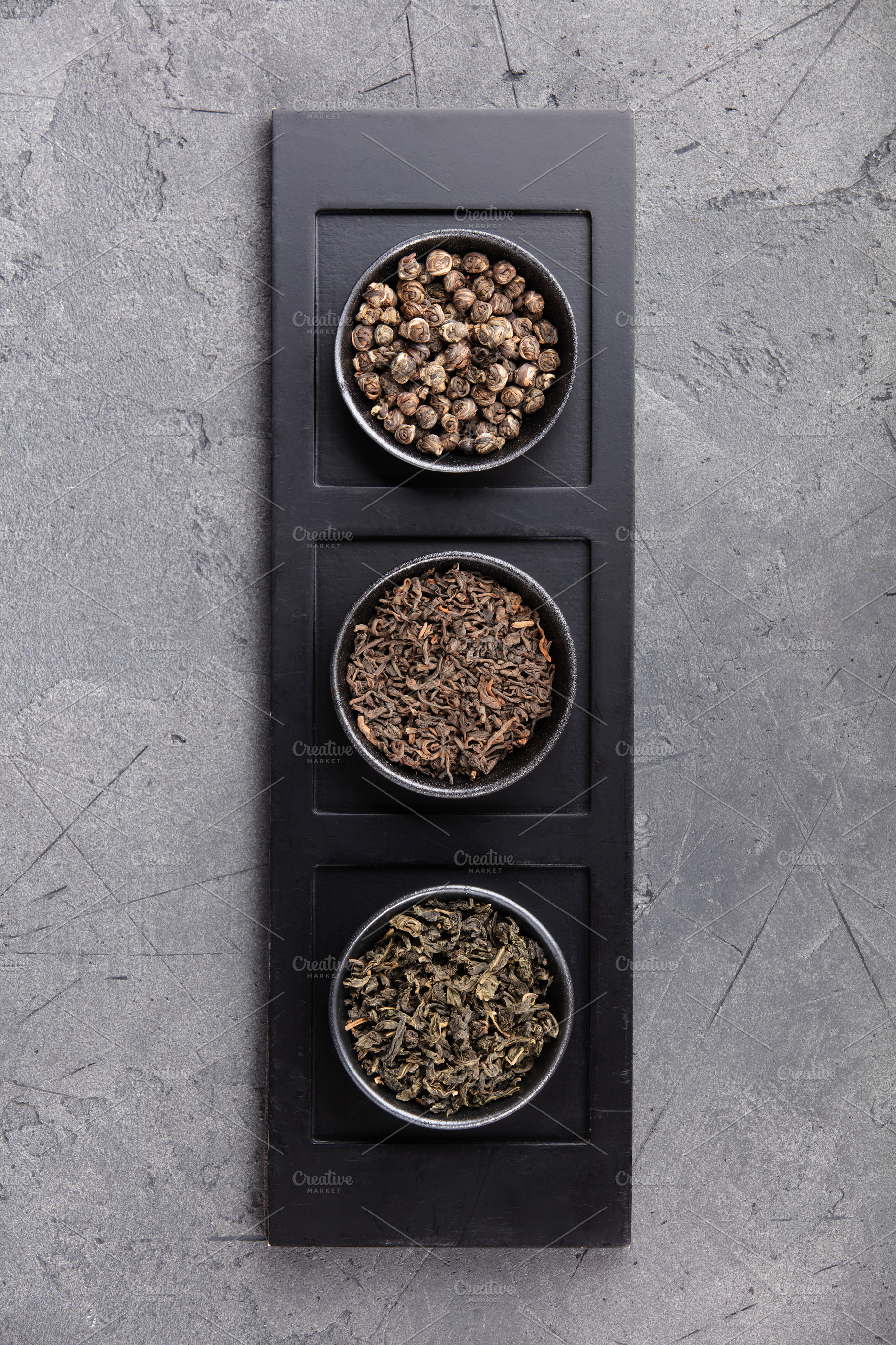 Assorted Loose Tea Leaves in Bowls on Dark Stone Background, a Holiday Photo by Natalia Klenova's Shop