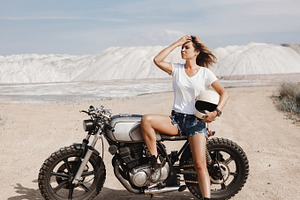 Female on custom built cafe racer motorcycle stock photo containing, a Transportation Photo by Aliaksei Kaponia