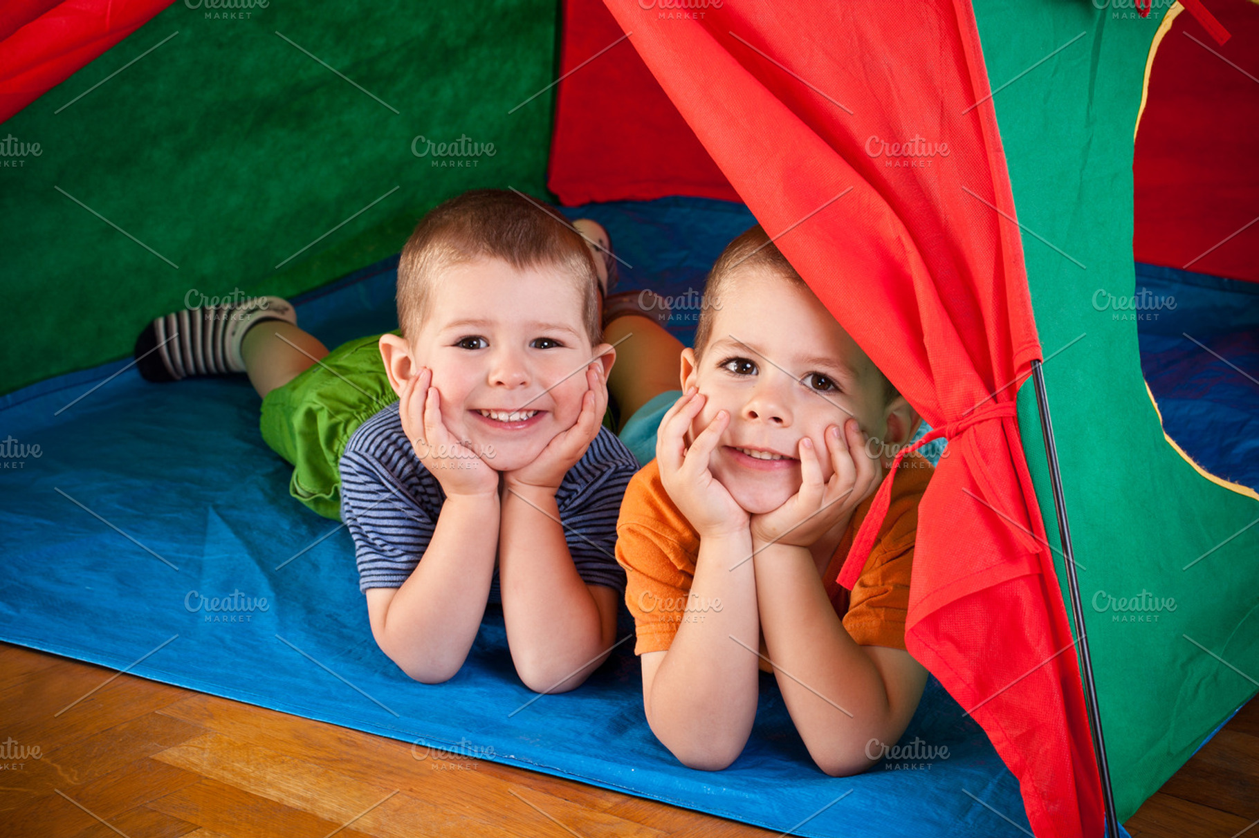 Little Boys Lying Inside Colorful Te