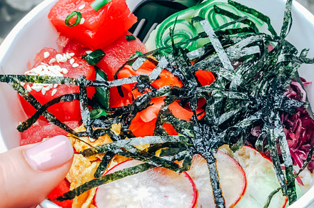 Poke bowl with tuna fish in paper container, a Food & Drink Photo by Dvoevnore photos