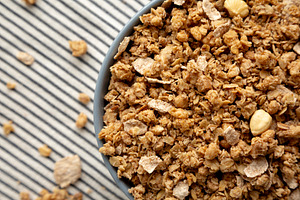 Healthy Homemade Toasted Muesli with Nuts in a Bowl, top view. C, a Food & Drink Photo by LiudmylaChuhunova