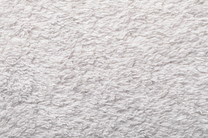 Close-up of soft white towel fabric with fluffy texture, perfect, a Background Photo by Ales Munt