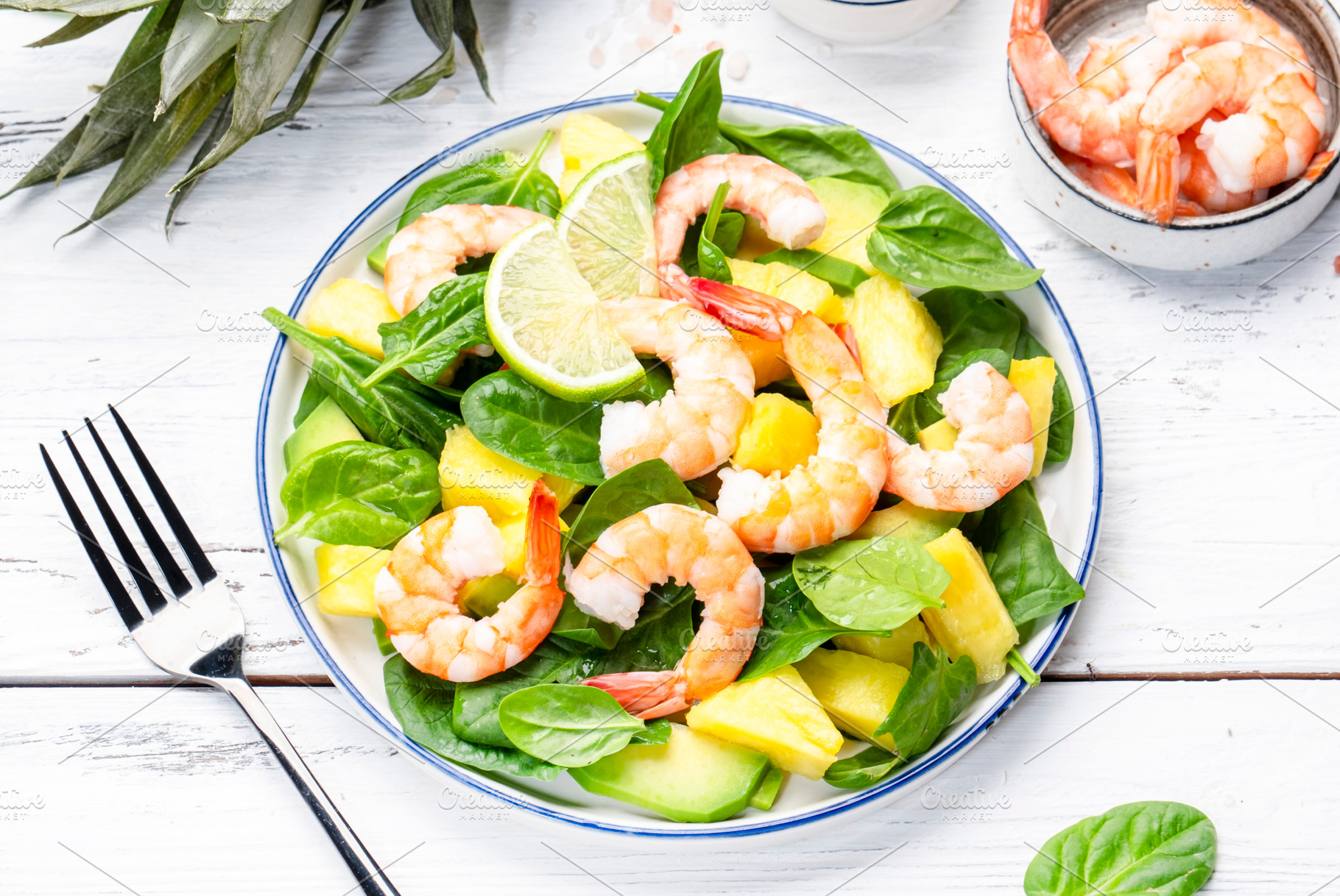 Shrimp pineapple salad with spinach, avocado and lime on white w, a Food & Drink Photo by 5PH