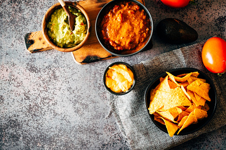 Mexican nachos with guacamole, cheddar cheese and chili.
