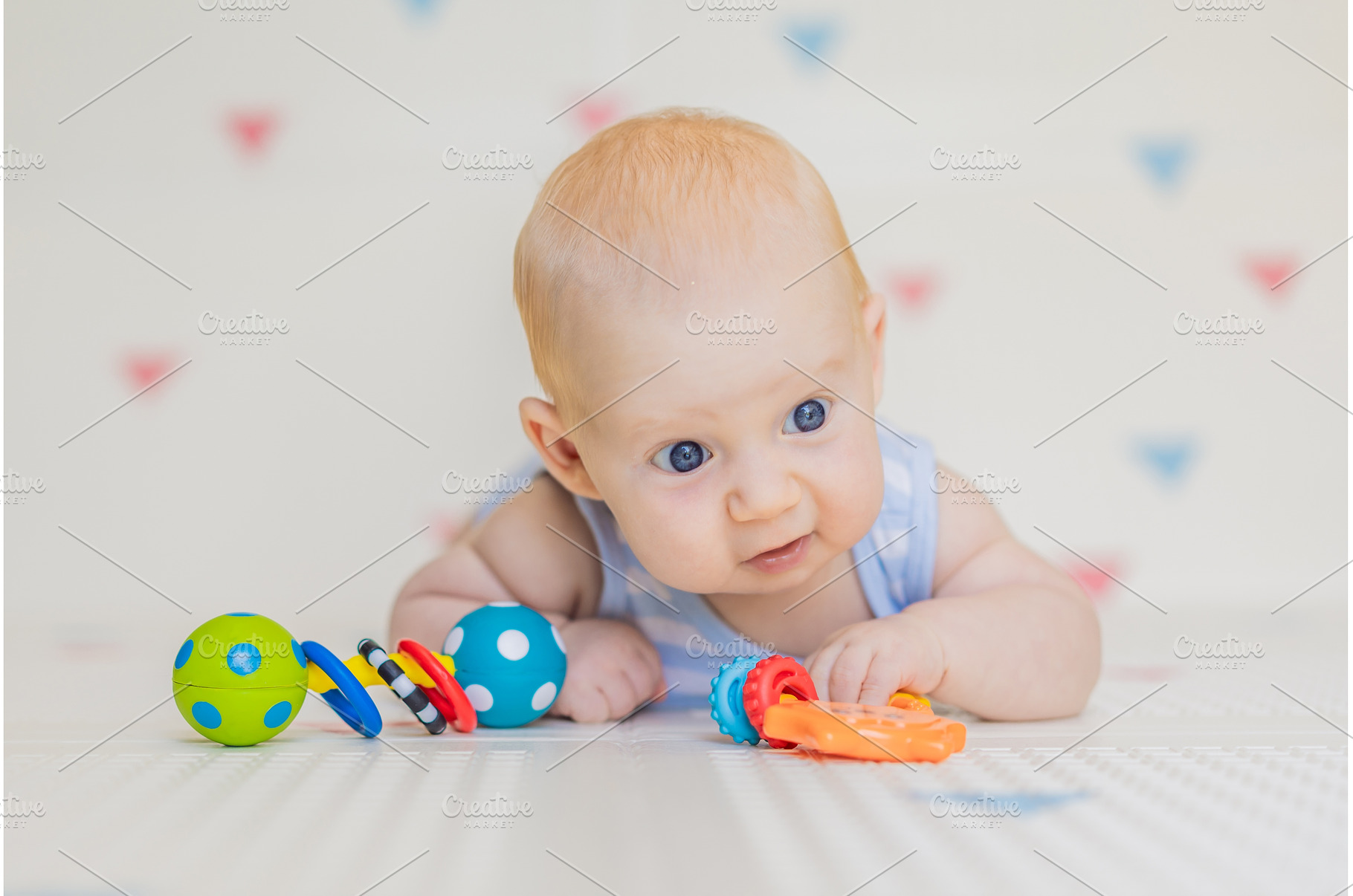 Adorable baby playing with colorful, a Background Photo by Elizaveta Galitskaya
