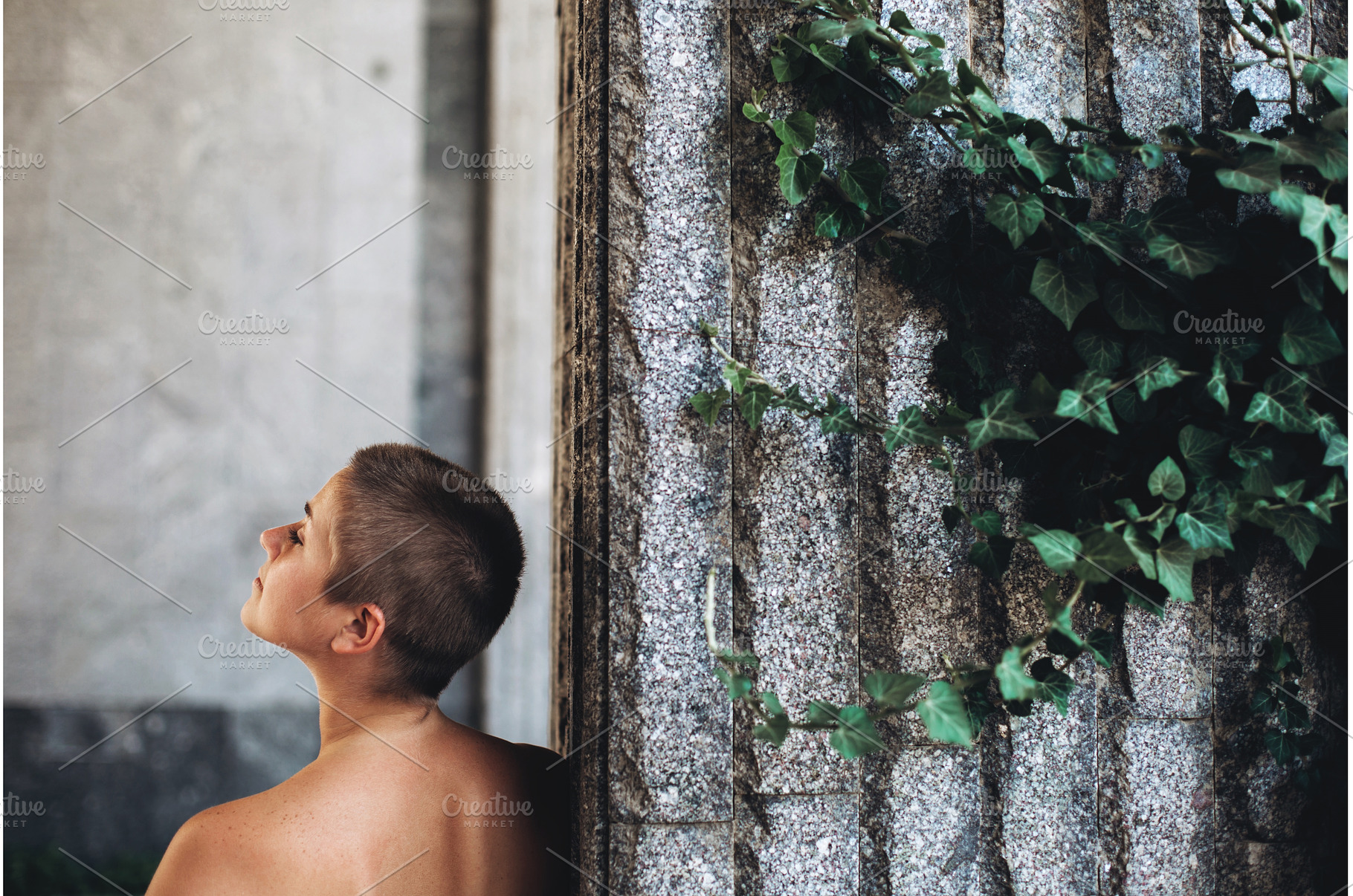 Person looking up near stone wall, a Beauty & Fashion Photo by Anna Efetova