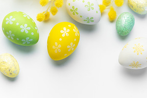 Easter eggs and mimosa creating spring holiday background, a Holiday Photo by Olena Rudo