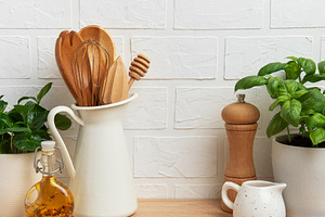 Kitchen utensils and ingredients resting on wooden countertop wi, a Food & Drink Photo by Olena Rudo