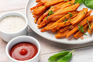 Sweet potato fries with ketchup and ranch sauces, a Food & Drink Photo by Olena Rudo
