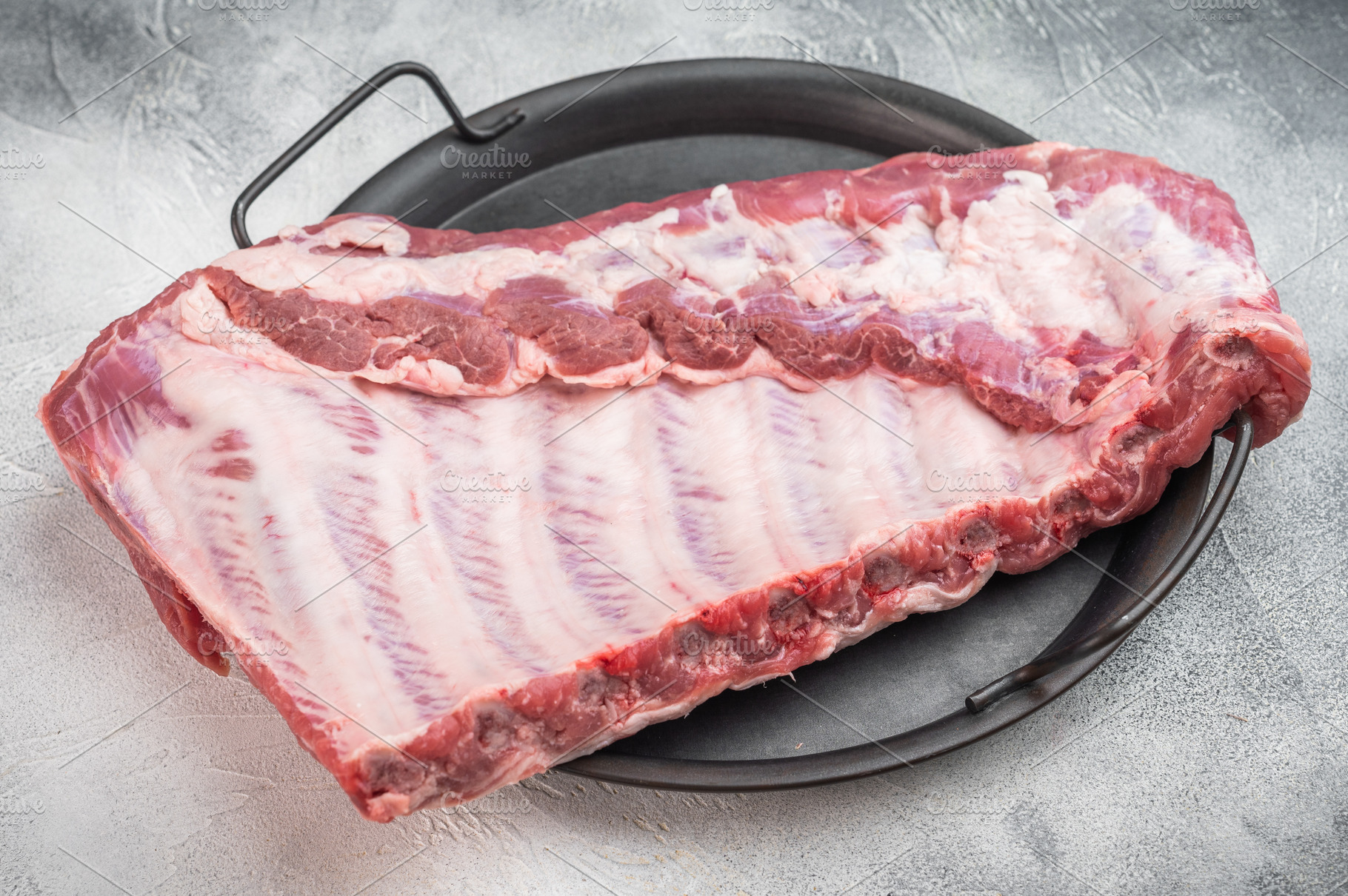 Raw pork spareribs rack in metal tray with rosemary thyme and ga, a Food & Drink Photo by composter-box@mail.ru
