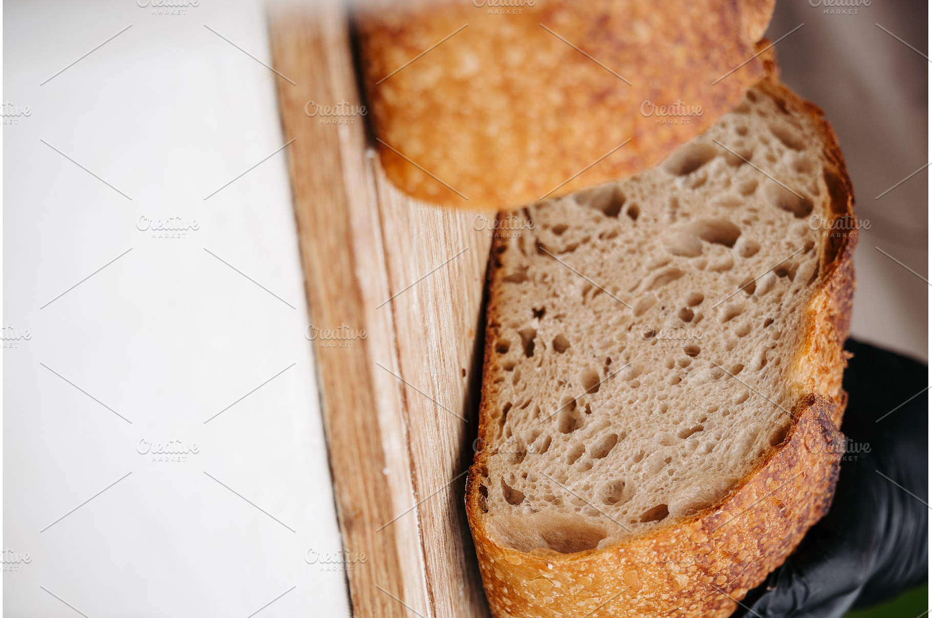 Fresh rustic sourdough bread on, a Food & Drink Photo by HalfPoint