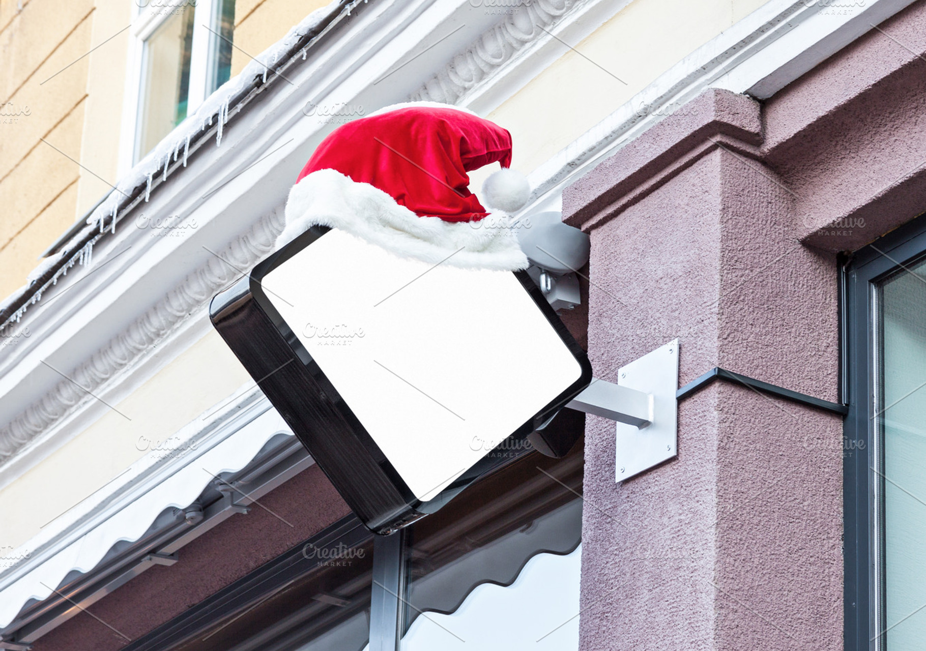 Company signage with Santa hat, a Business Photo by BOOCYS