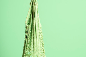 Yellow melon hanging in reusable mes
