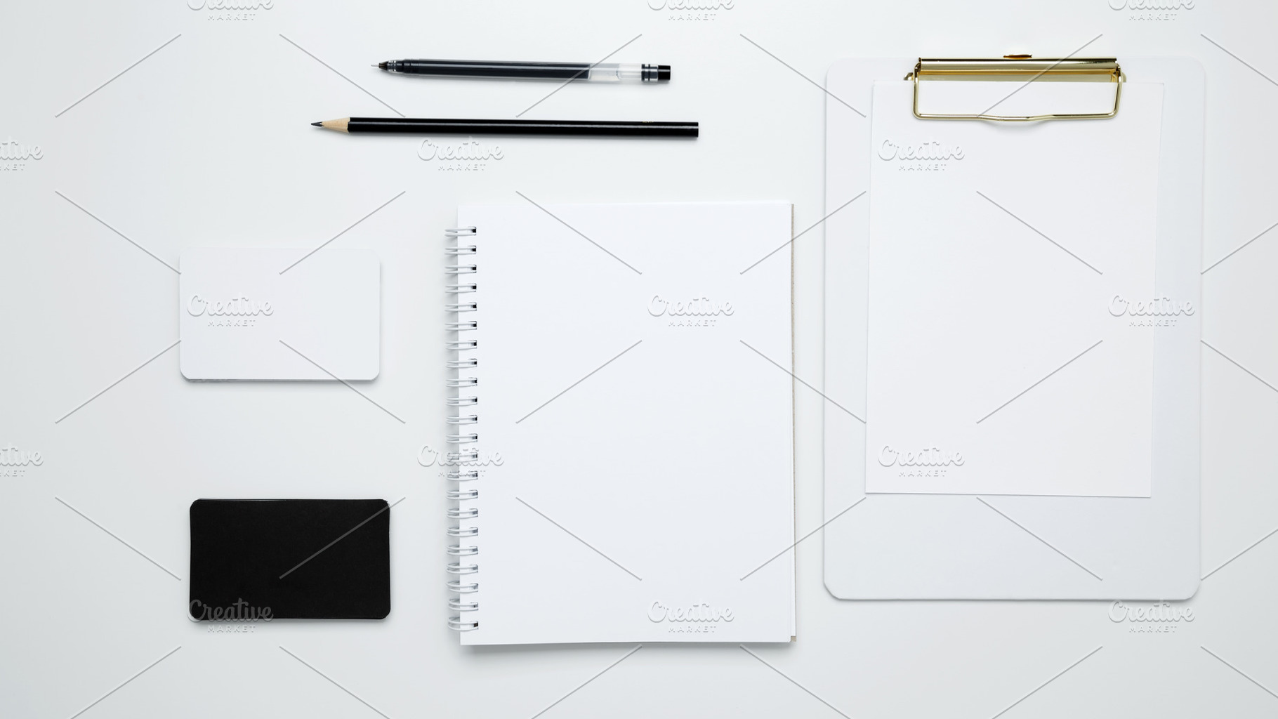 Monochrome stationery items. On a white background, an empty mock up notebook a, a Photo by matucha
