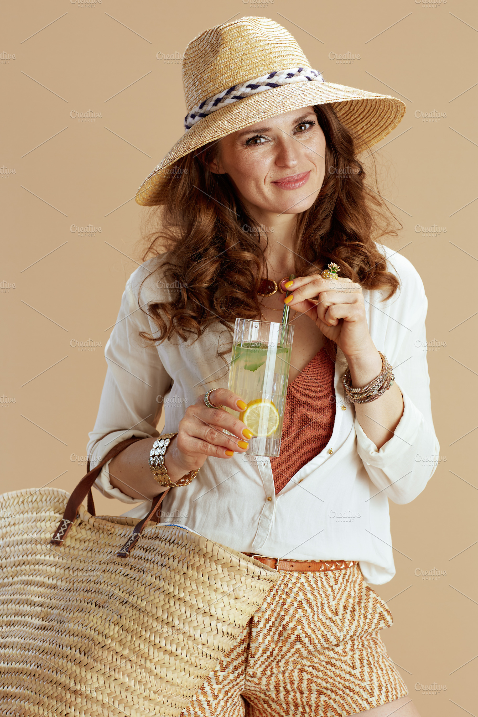 happy woman in blouse and shorts isolated on beige, a Person Photo by Alliance Images