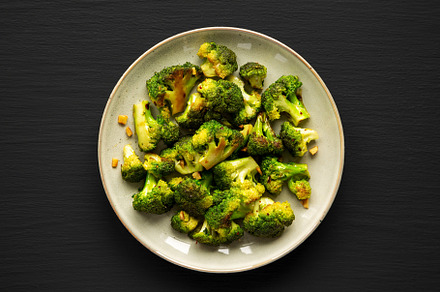 Homemade Pan-Fried Broccoli on a Plate on a black background, to, a Food & Drink Photo by LiudmylaChuhunova